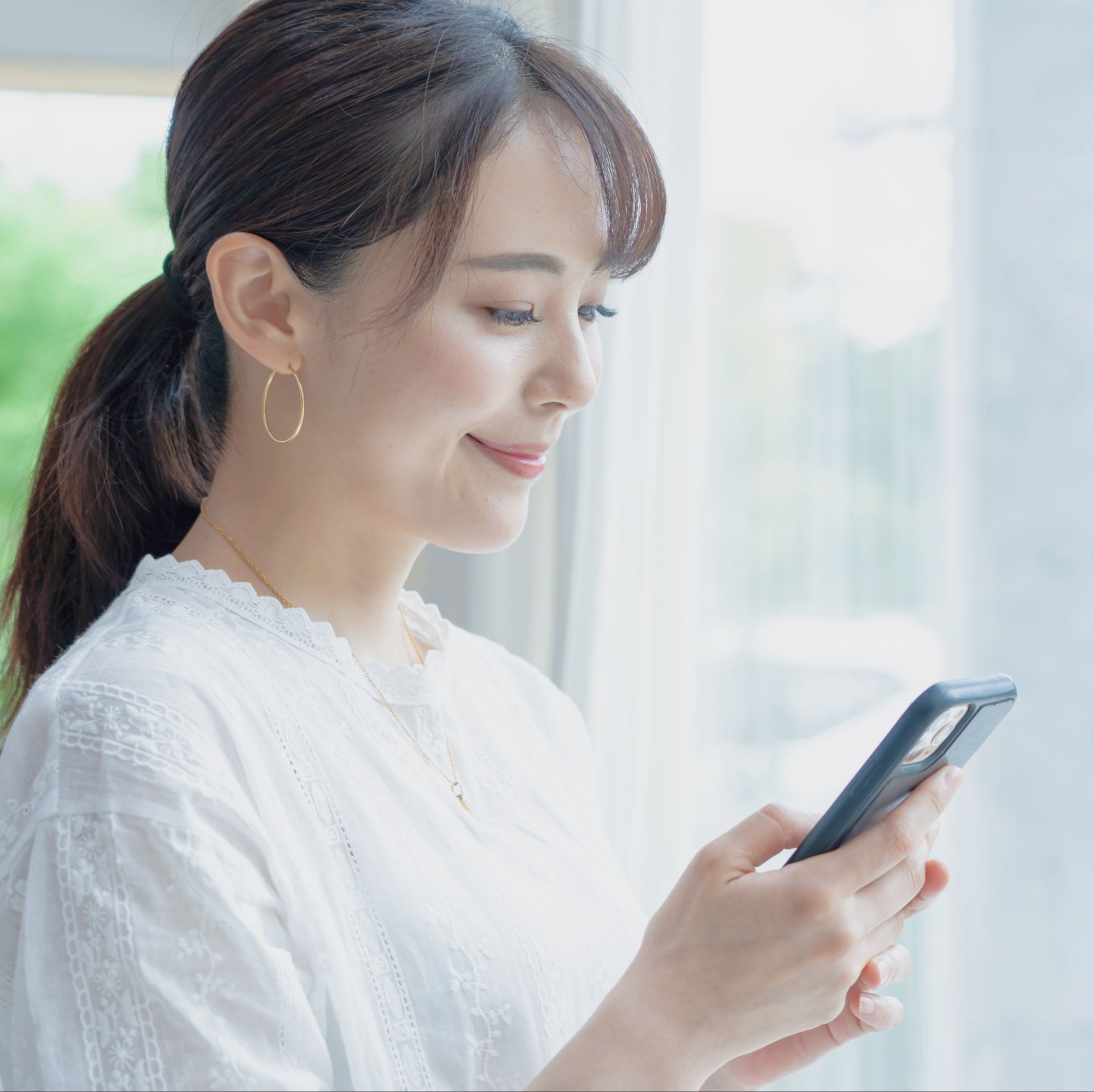 スマートフォンで申し込む女性
